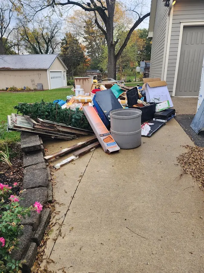 Dumpster being loaded with debris for Demolition Dumpster Rental in Needham